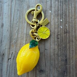 Yellow and green lemon keychains brass and enamel .